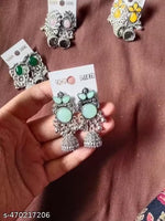 stunning oxidized silver jhumkas feature vibrant red, green, and pink hues