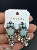 stunning oxidized silver jhumkas feature vibrant red, green, and pink hues